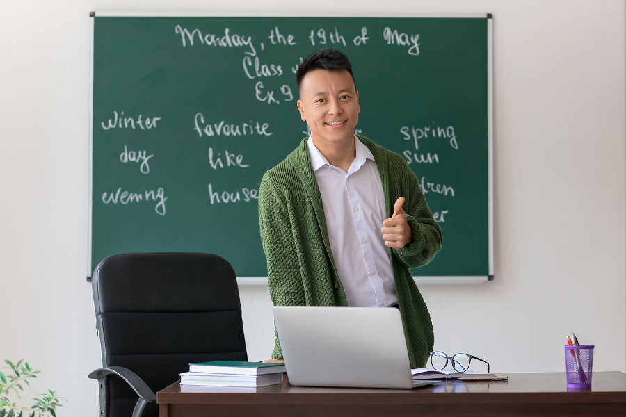 Person teaching an English class, points to English class resources.