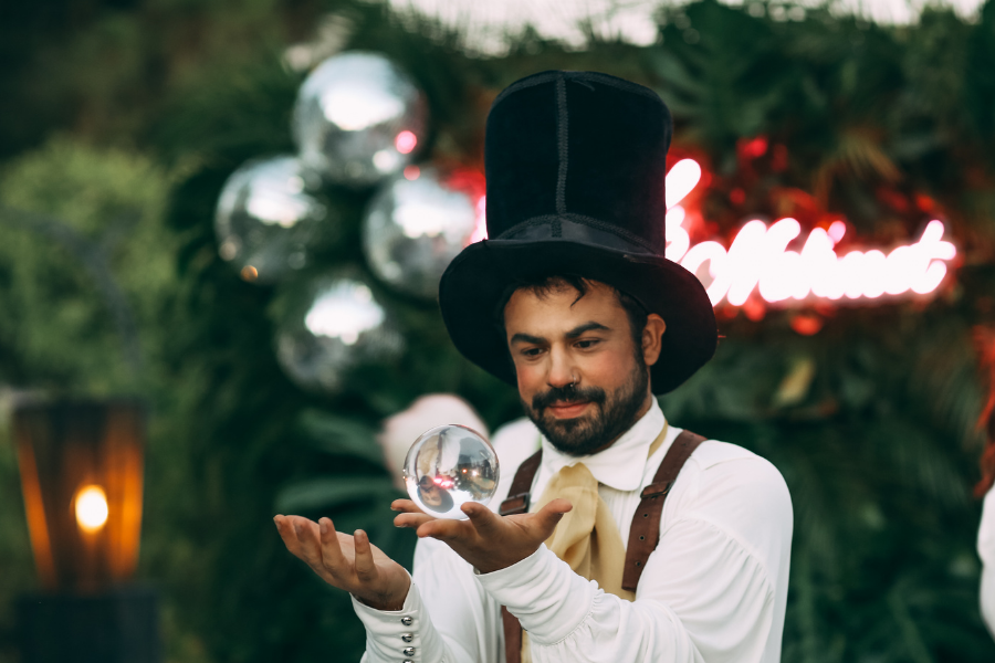 A magician putting on a show, points to WPL's event calendar.