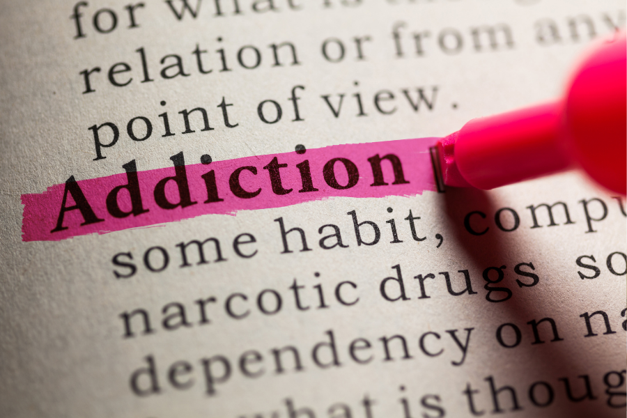 Text in a book with addiction highlighted, points to addiction resources.
