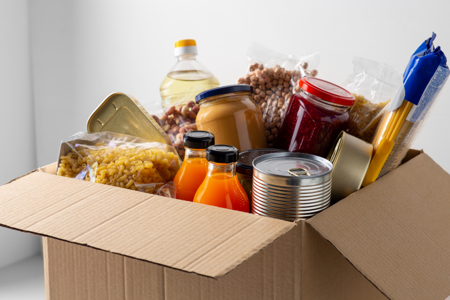 Box of non-perishable food items, points to hot meal and food pantry resources.