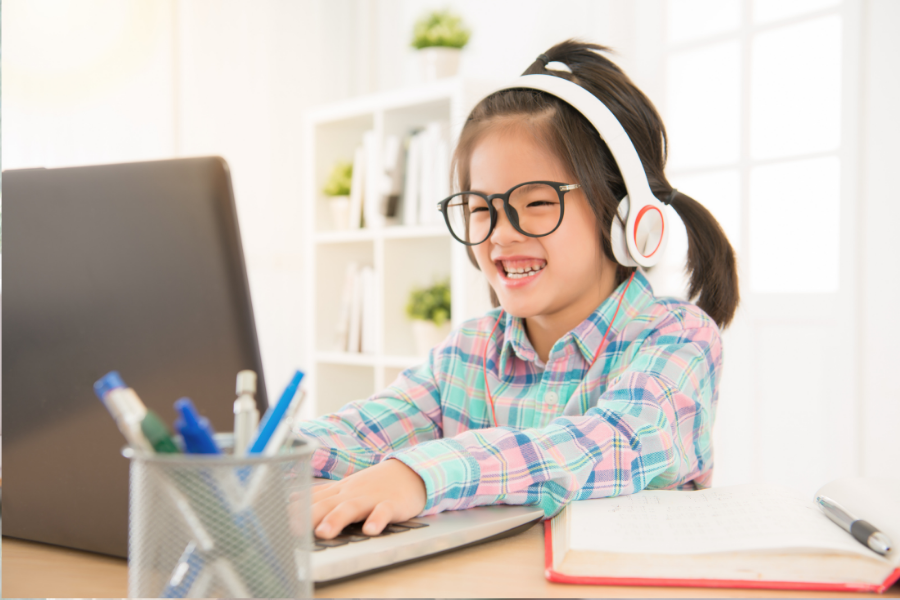 Kid playing on computer.